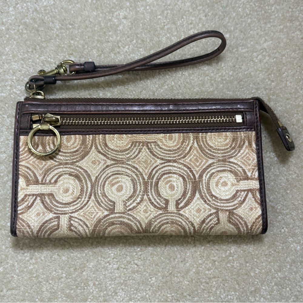 Coach Optic Swirl logo wallet with a detachable wrist strap